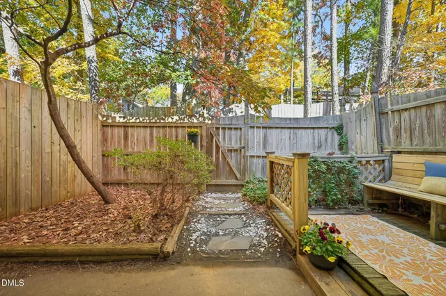 a view of balcony with wooden floor and fence