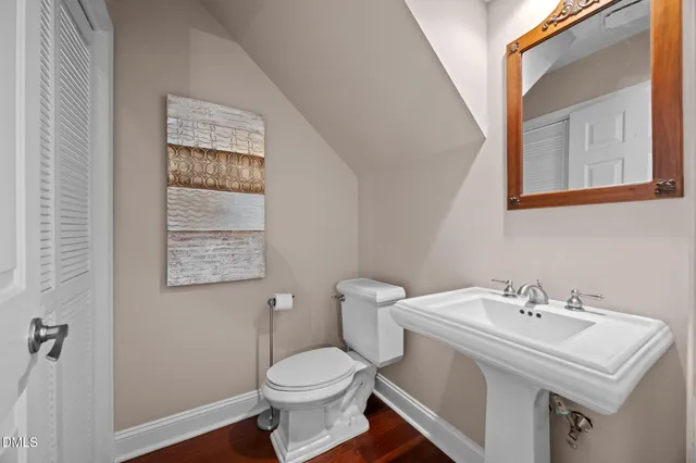 a bathroom with a sink toilet and a mirror