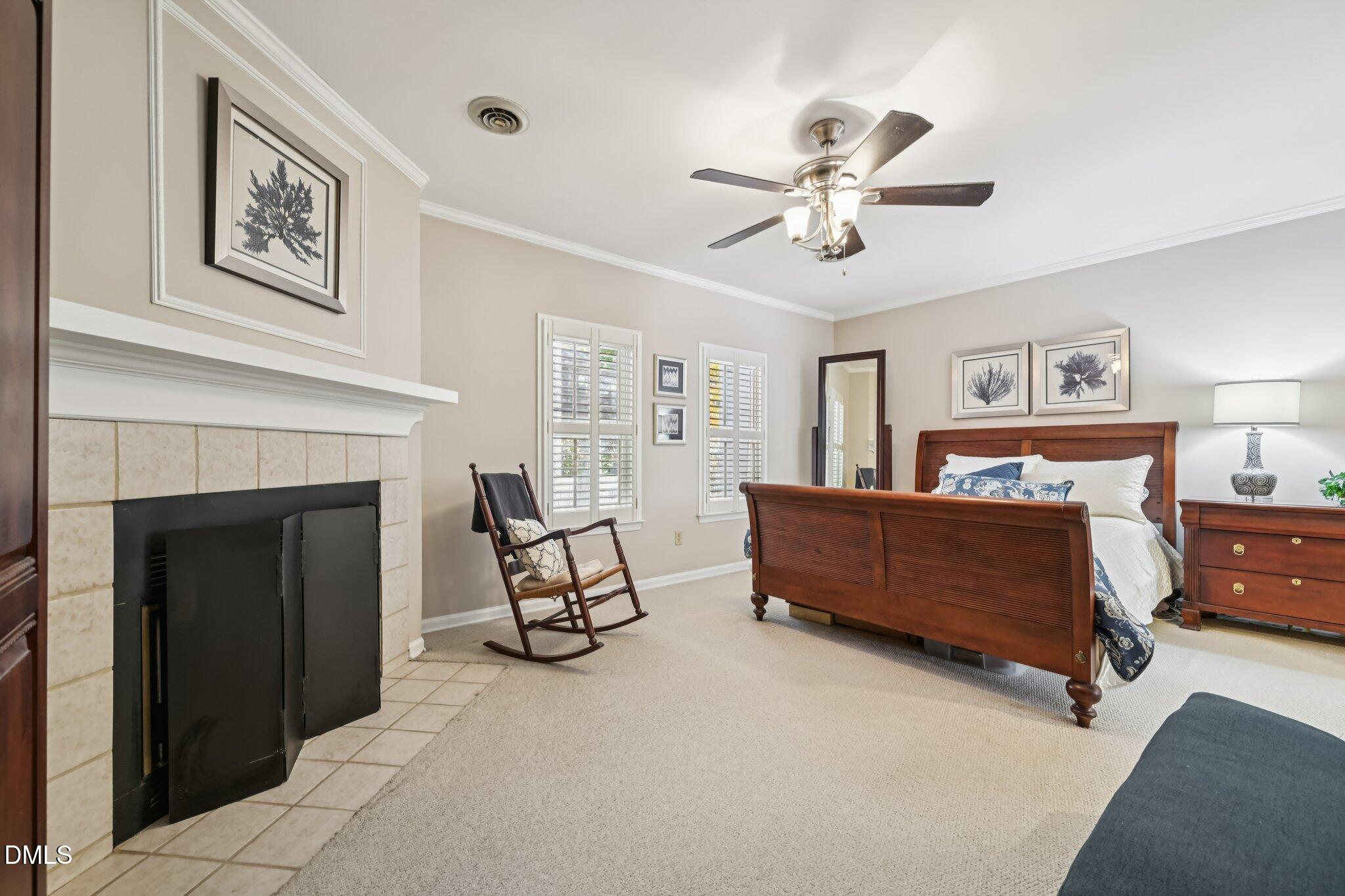 5530 Forest Oaks Drive Raleigh, NC 27609 - Photo 7 of 12 a bedroom with furniture and a fireplace