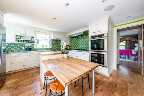 a dining room with furniture a chandelier and wooden floor