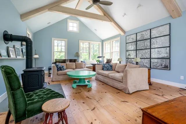 a bed room with a bed and a painting on the wall