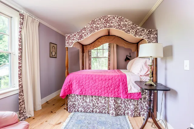 a bedroom with bed and a window