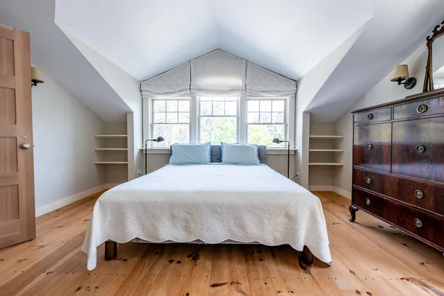 a backyard of a house with swimming pool and large trees