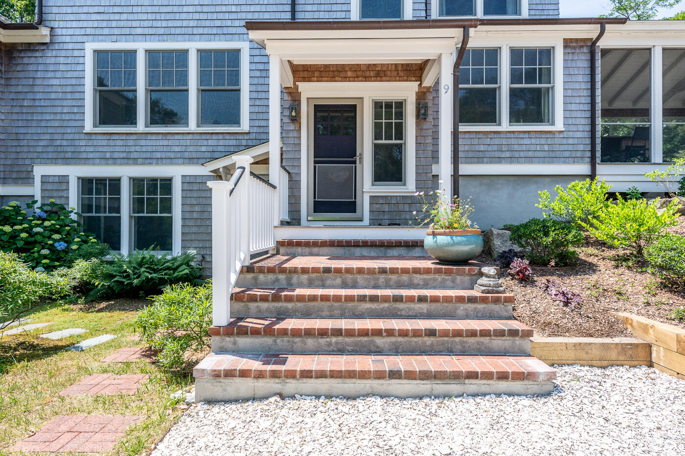9 Towhee Lane Truro, MA 02666 - Photo 6 of 62 a front view of a house with plants and windows