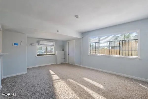 a view of a livingroom with an empty space and a window