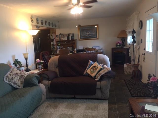 4665 Highway 9 Mill Spring, NC 28756 - Photo 3 of 12 a living room with furniture and a lamp