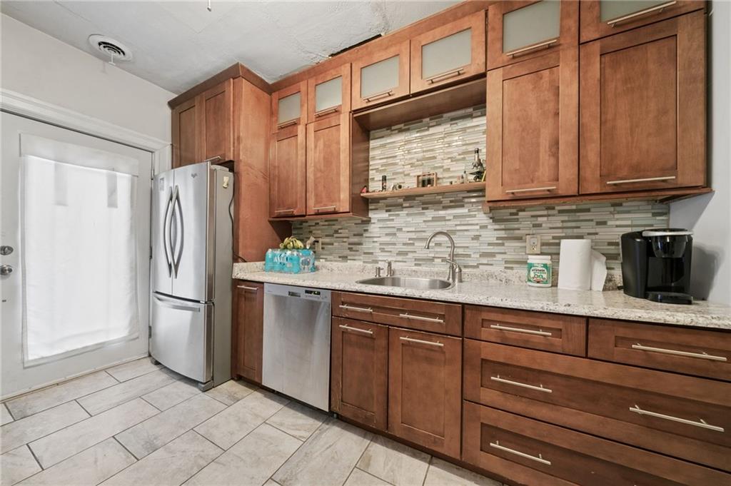1523 Evergreen Road Pittsburgh, PA 15209 - Photo 20 of 35 a kitchen with stainless steel appliances granite countertop a refrigerator and a sink
