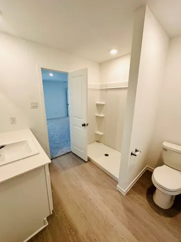 a bathroom with a toilet and a shower