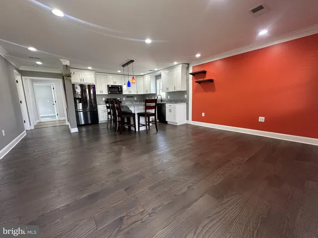 a view of a room with wooden floor and furniture