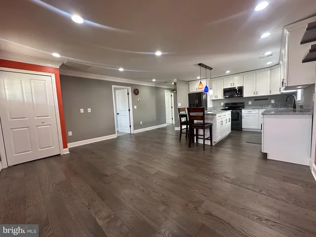 a view of kitchen with cabinets and wooden floor