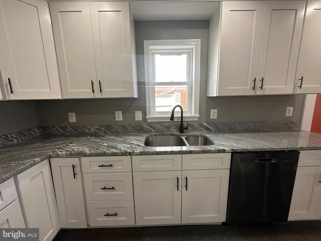 a kitchen with appliances cabinets and a sink