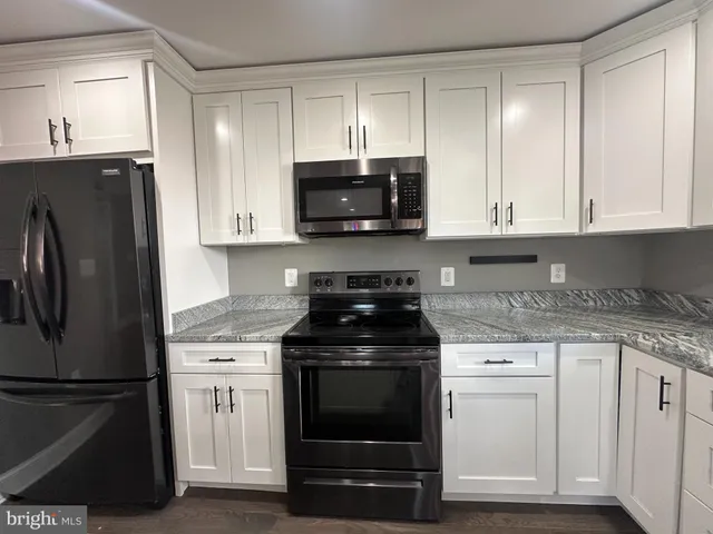 a kitchen with a stove and a refrigerator