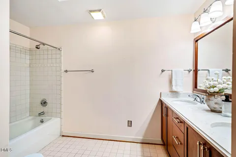 a bathroom with a tub sink and mirror