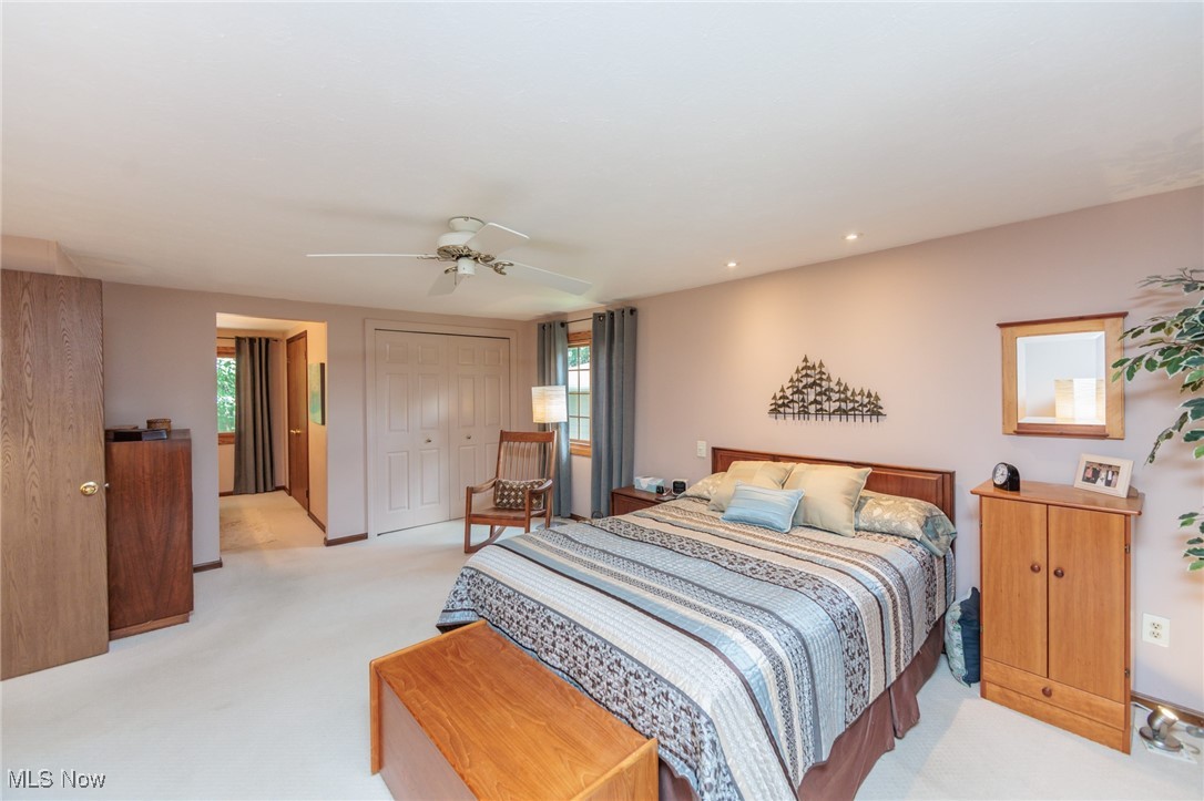 37451 Hunters Ridge Solon, OH 44139 - Photo 24 of 42 Bedroom with light colored carpet, a closet, and a ceiling fan