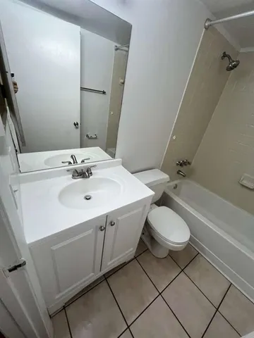 a bathroom with a sink mirror vanity and toilet