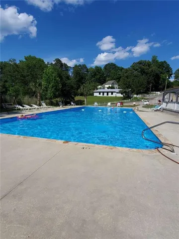 a view of swimming pool with a yard