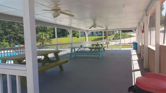 a view of a porch with furniture and a yard