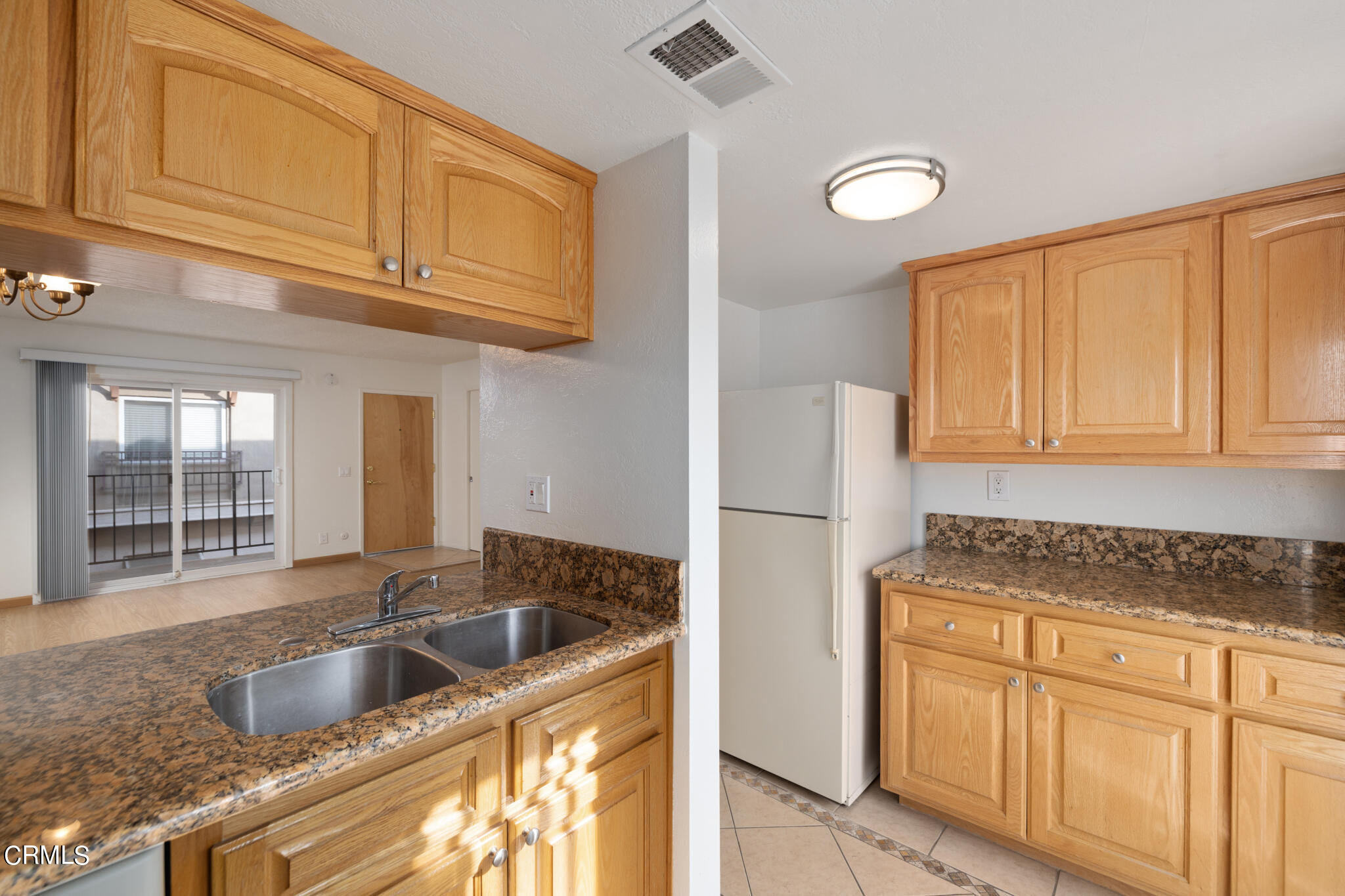 2429 Oswego Street, Unit B Pasadena, CA 91107 - Photo 11 of 25 a kitchen with granite countertop a sink cabinets and refrigerator