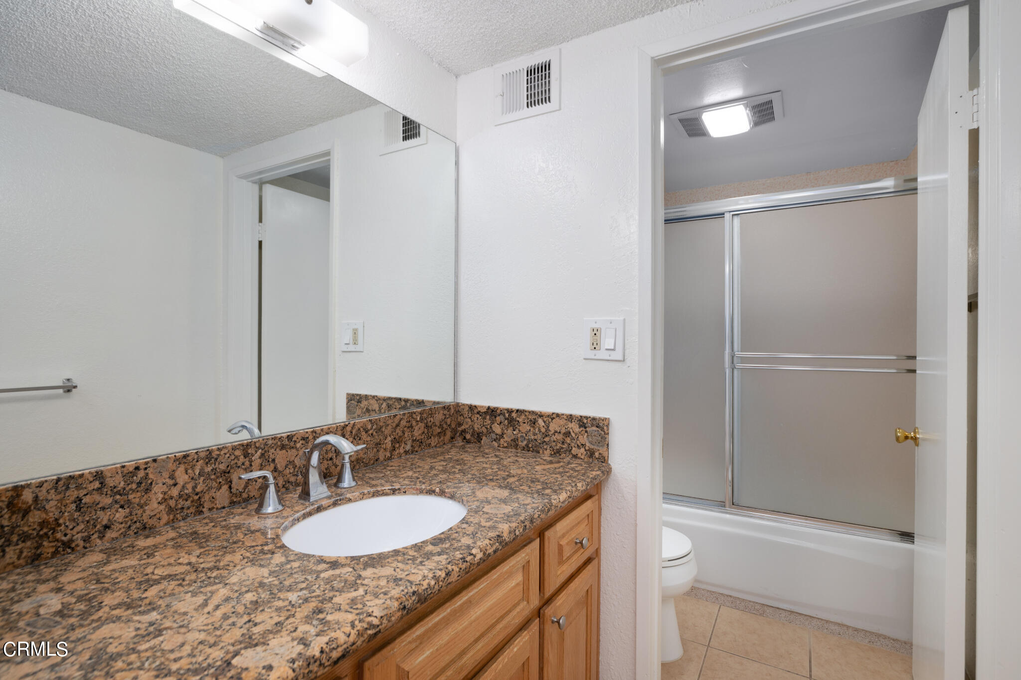 2429 Oswego Street, Unit B Pasadena, CA 91107 - Photo 17 of 25 a bathroom with a granite countertop sink and a mirror