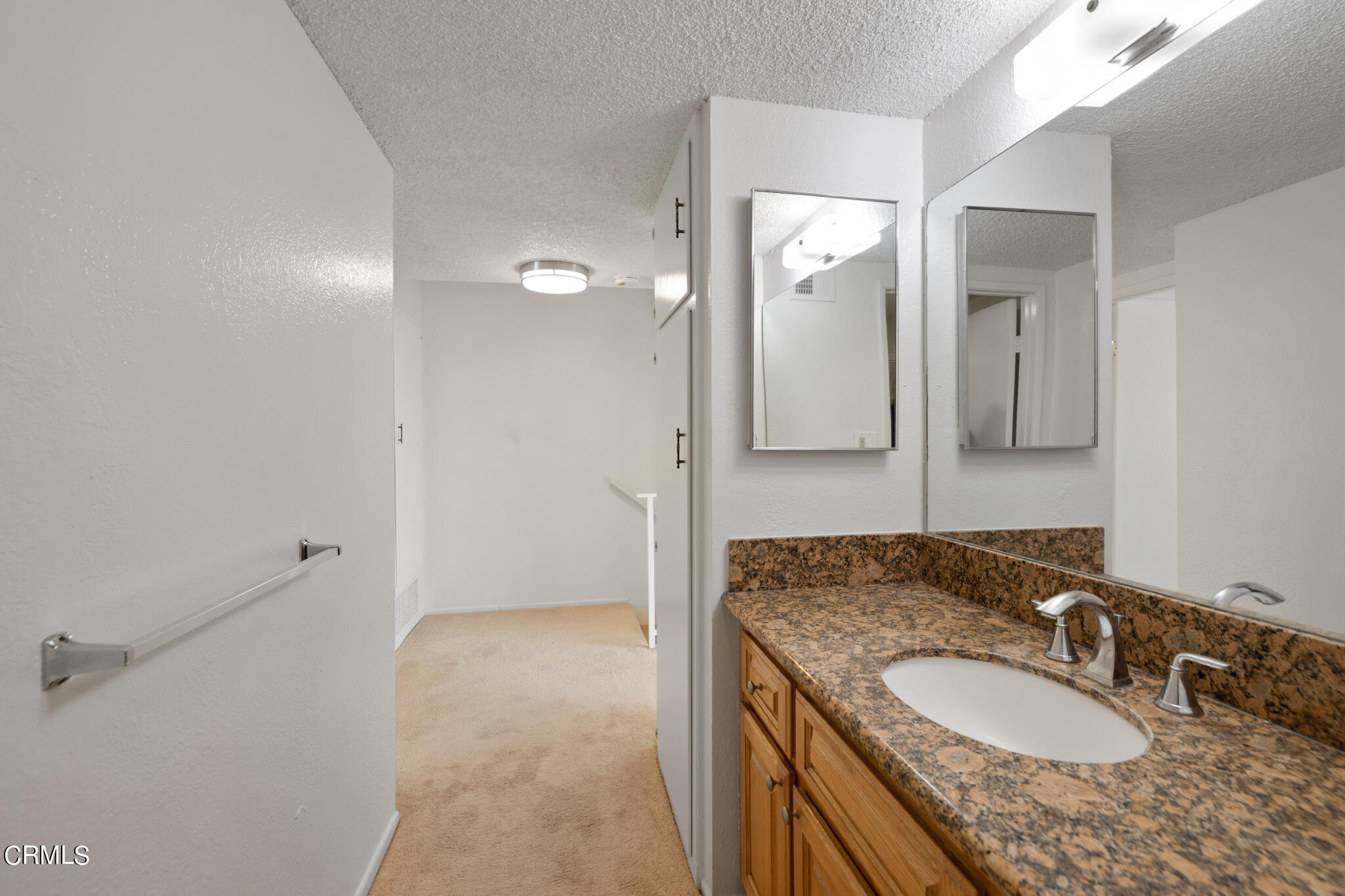 2429 Oswego Street, Unit B Pasadena, CA 91107 - Photo 20 of 25 a bathroom with a granite countertop sink and mirror