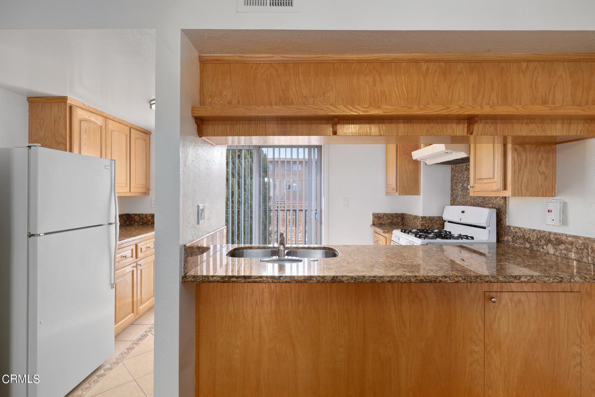 2429 Oswego Street, Unit B Pasadena, CA 91107 - Photo 9 of 25 a bathroom with a granite countertop sink and a mirror