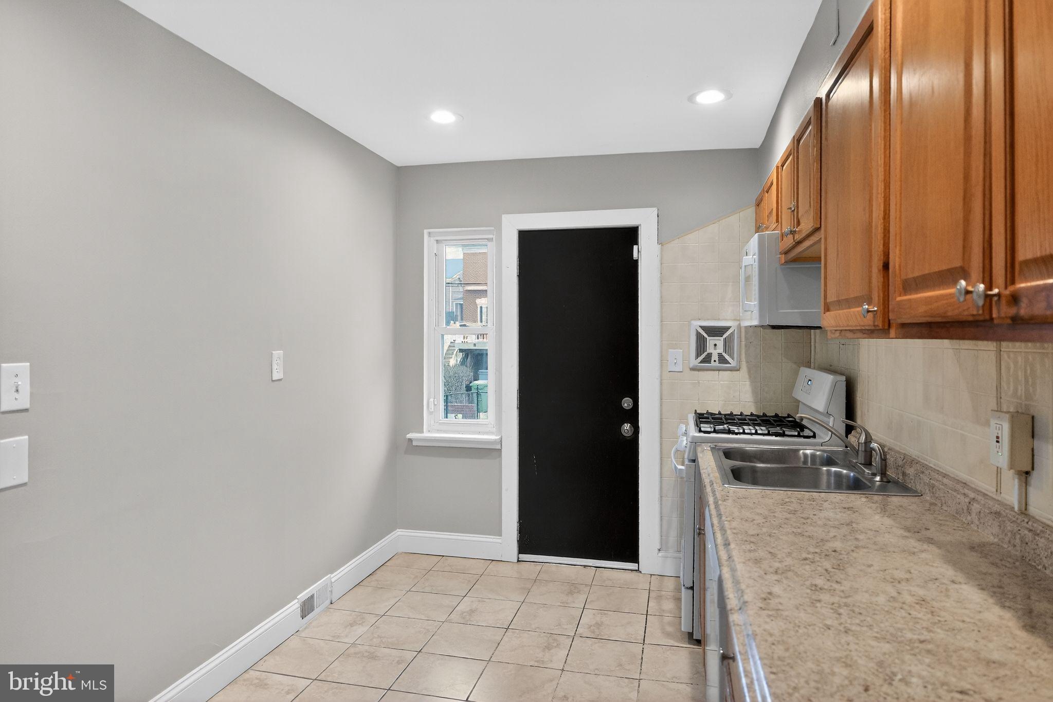 2018 Winford Road Baltimore, MD 21239 - Photo 10 of 29 a kitchen with stainless steel appliances granite countertop a refrigerator and a sink