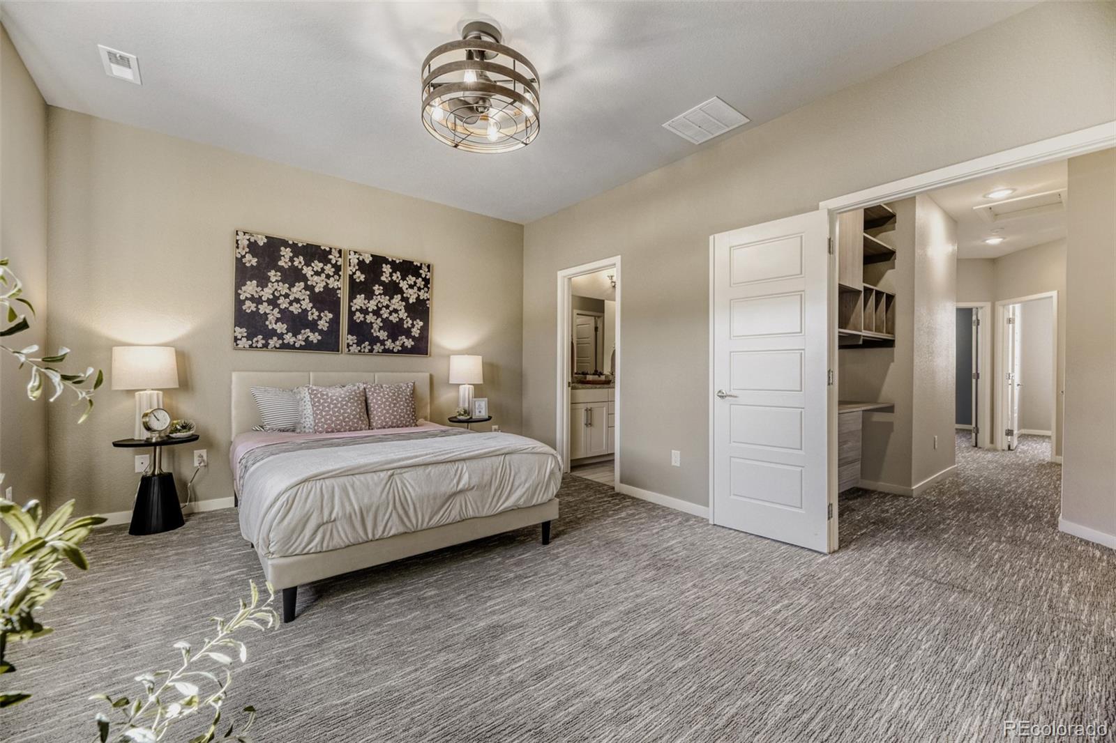 11691 West 45th Place Wheat Ridge, CO 80033 - Photo 14 of 30 a spacious bedroom with a bed and a chandelier