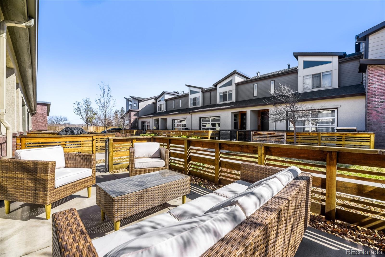 11691 West 45th Place Wheat Ridge, CO 80033 - Photo 24 of 30 a view of a swimming pool with couches chairs and wooden floor