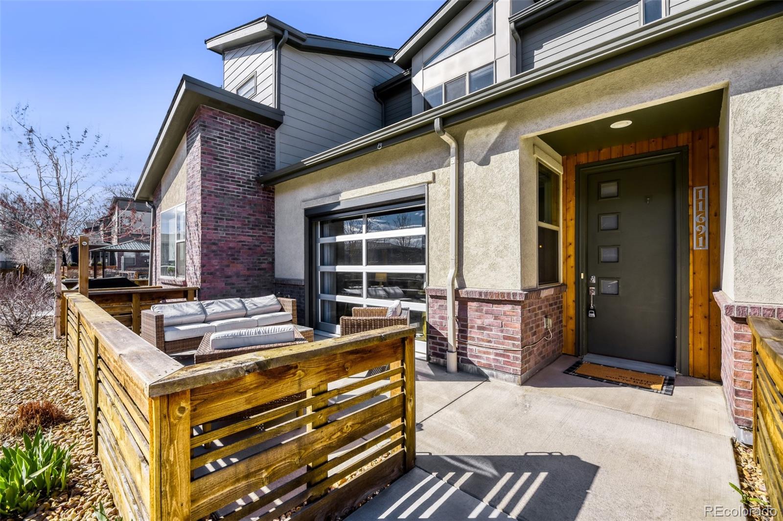 11691 West 45th Place Wheat Ridge, CO 80033 - Photo 3 of 30 a front view of a house with barbeque and wooden fence