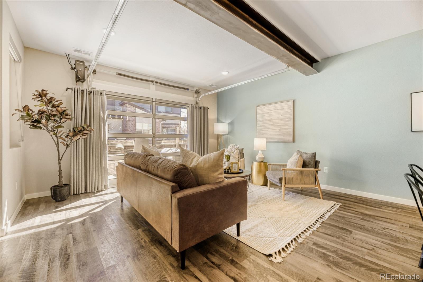 11691 West 45th Place Wheat Ridge, CO 80033 - Photo 8 of 30 a living room with furniture and a potted plant