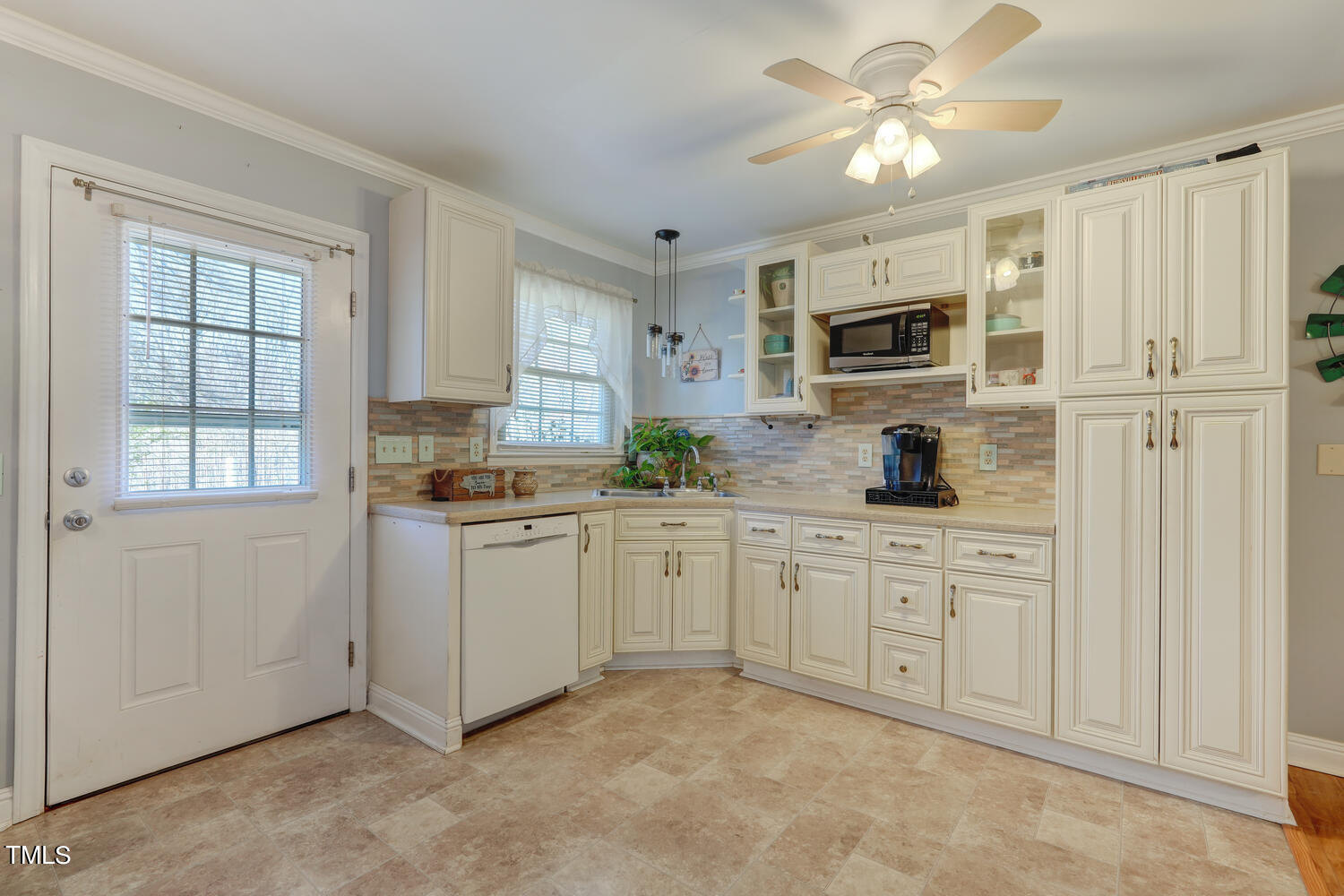 650 Huffines Mill Road Reidsville, NC 27320 - Photo 18 of 35 a kitchen with white cabinets and window
