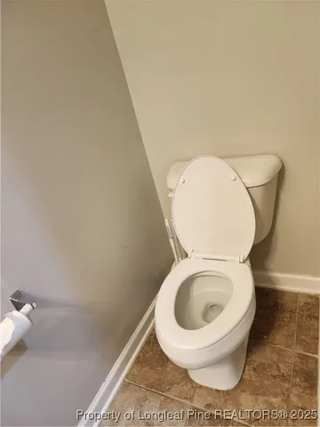 an empty room with wooden floor and a window