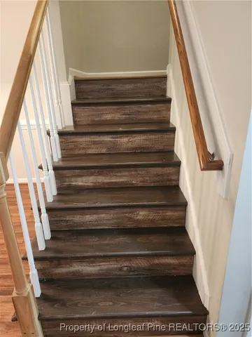 an empty room with wooden floor and closet