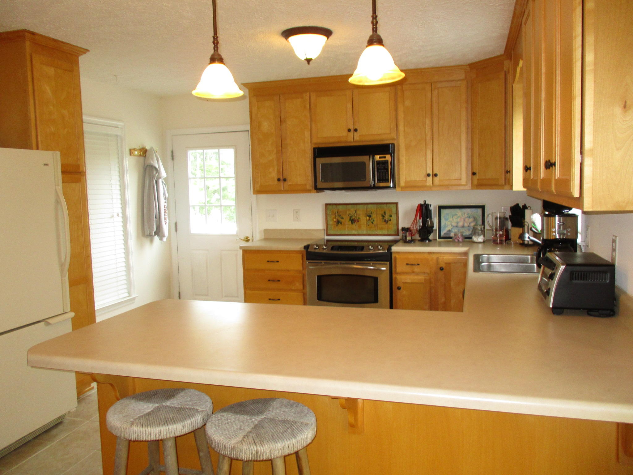115 Marcom Drive Northwest Riner, VA 24149 - Photo 8 of 31 a kitchen with a table chairs microwave and cabinets