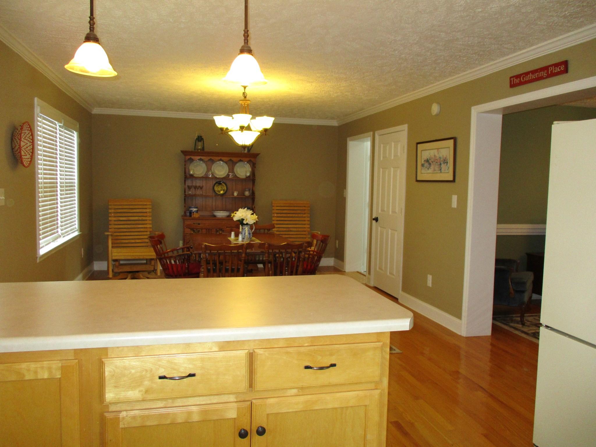 115 Marcom Drive Northwest Riner, VA 24149 - Photo 9 of 31 a kitchen with a refrigerator and wooden floor