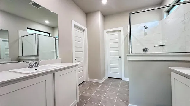 a bathroom with a sink a mirror and a shower