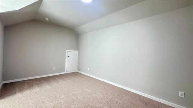 an empty room with closet and natural light