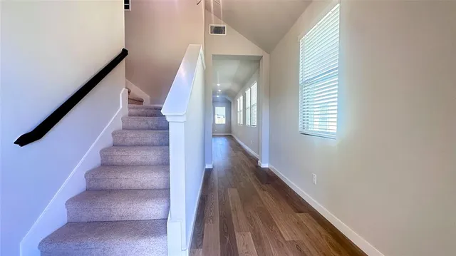 a view of entryway and hall with wooden floor