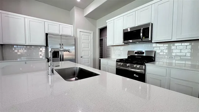 a view of empty room with wooden floor and window