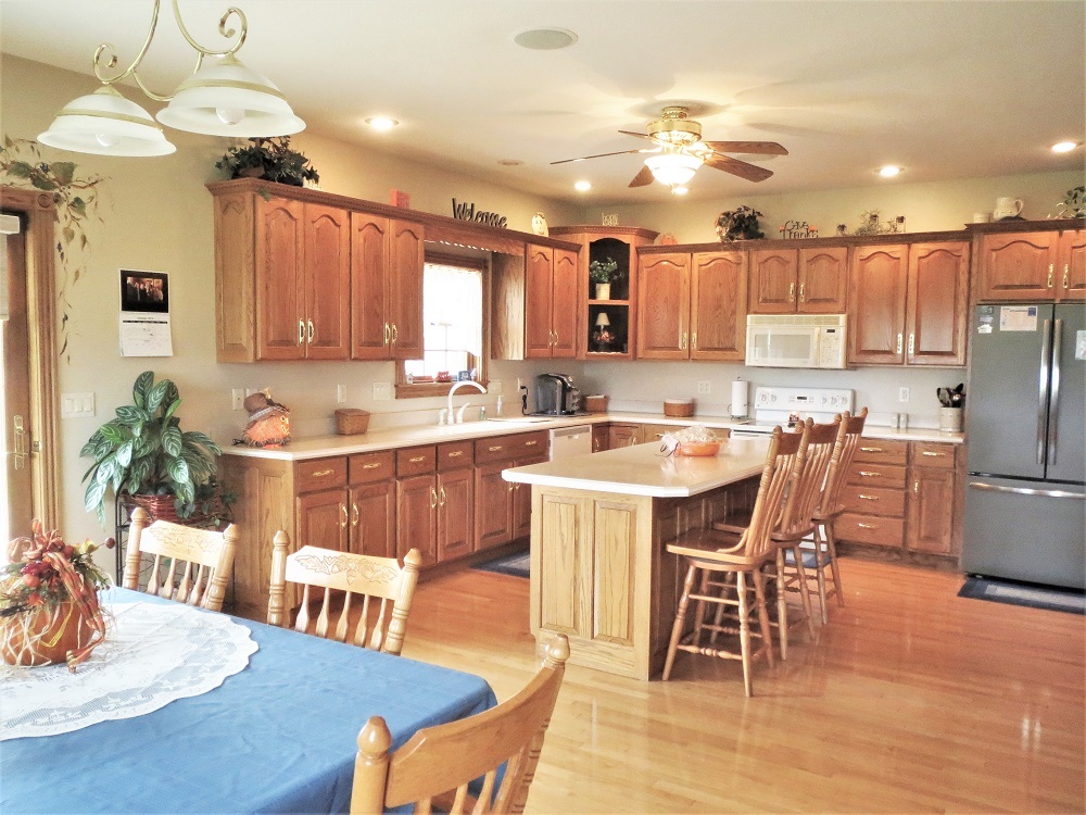 1122 Sterling Road Dixon, IL 61021 - Photo 3 of 45 a kitchen with stainless steel appliances kitchen island granite countertop a dining table chairs sink refrigerator and microwave