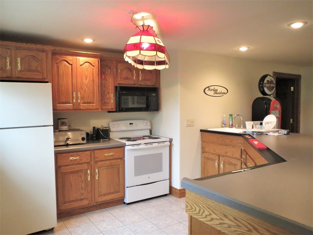 1122 Sterling Road Dixon, IL 61021 - Photo 26 of 45 a kitchen with a stove a sink and a refrigerator