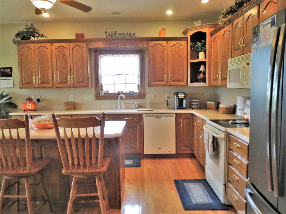 1122 Sterling Road Dixon, IL 61021 - Photo 4 of 45 a kitchen with stainless steel appliances a microwave a sink a stove a table and chairs