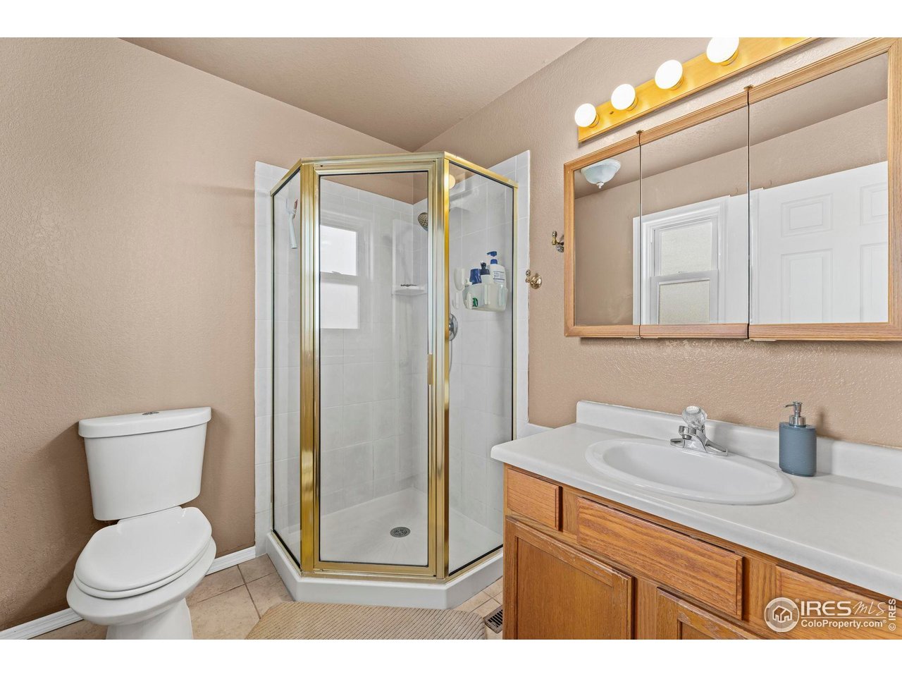 124 Adams Way Firestone, CO 80520 - Photo 14 of 34 a bathroom with a granite countertop toilet sink and shower
