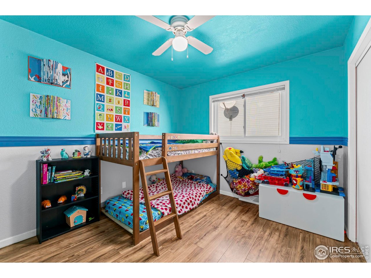 124 Adams Way Firestone, CO 80520 - Photo 15 of 34 a bedroom with furniture and a book shelf