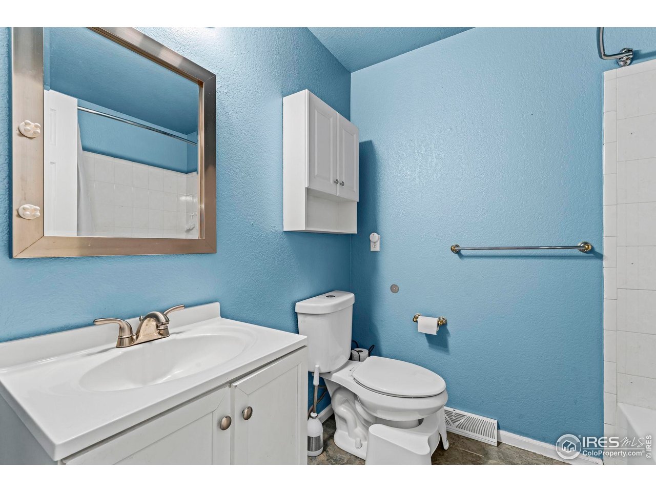 124 Adams Way Firestone, CO 80520 - Photo 16 of 34 a bathroom with a sink a toilet and mirror