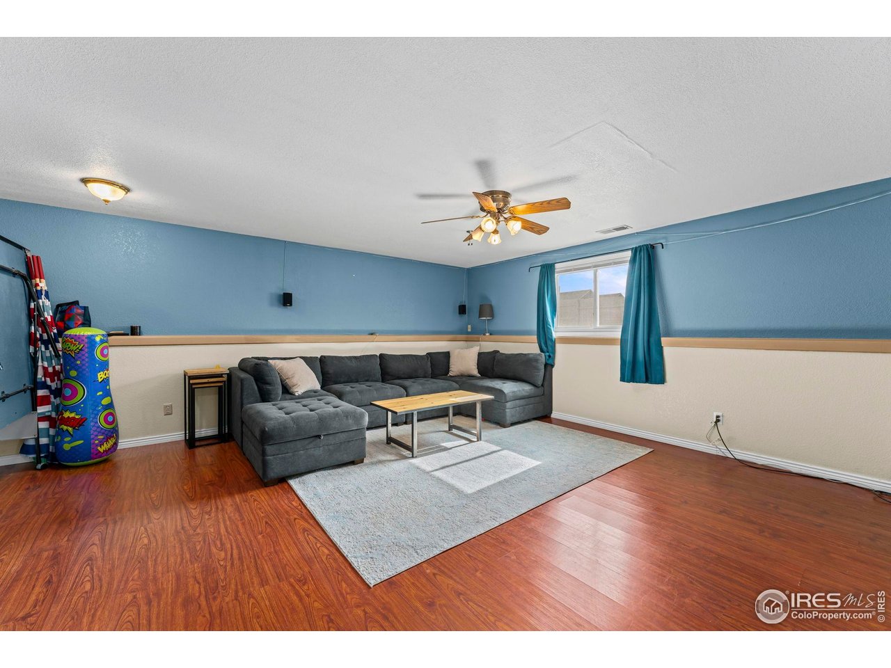 124 Adams Way Firestone, CO 80520 - Photo 18 of 34 a living room with furniture and wooden floor
