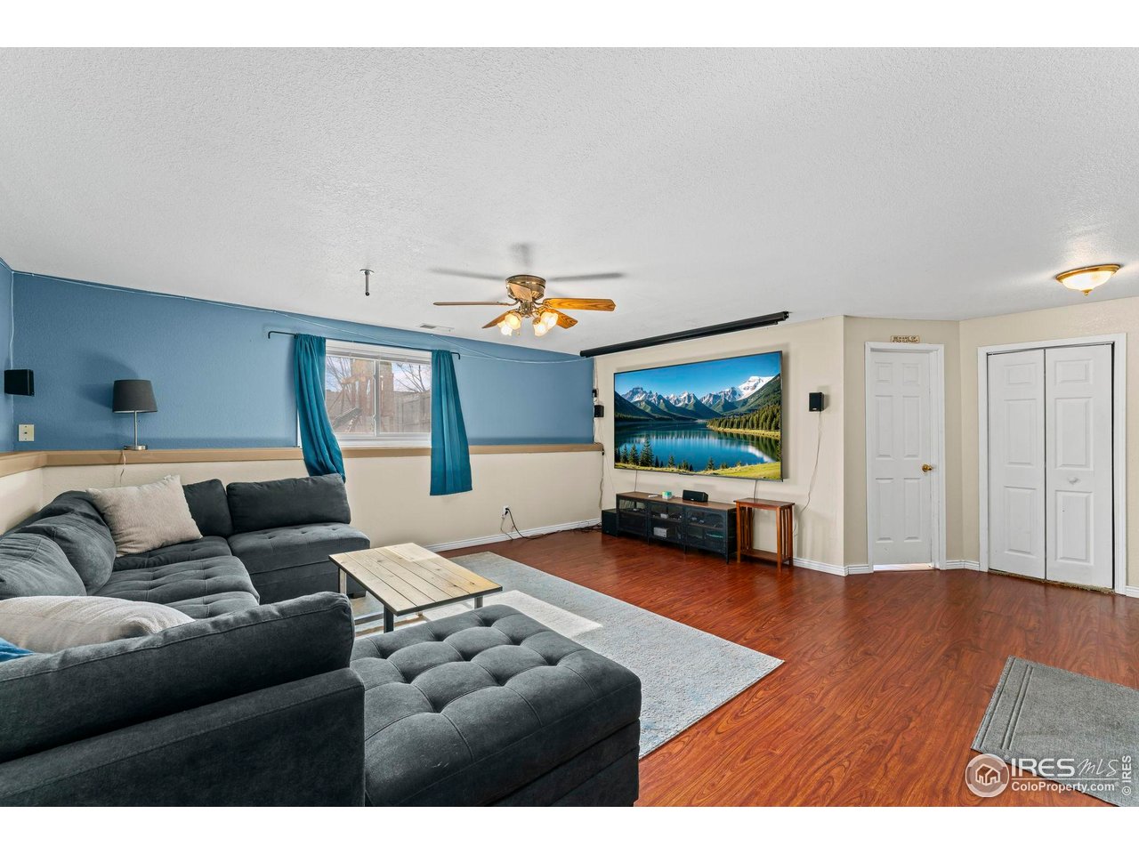 124 Adams Way Firestone, CO 80520 - Photo 19 of 34 a living room with furniture and a flat screen tv