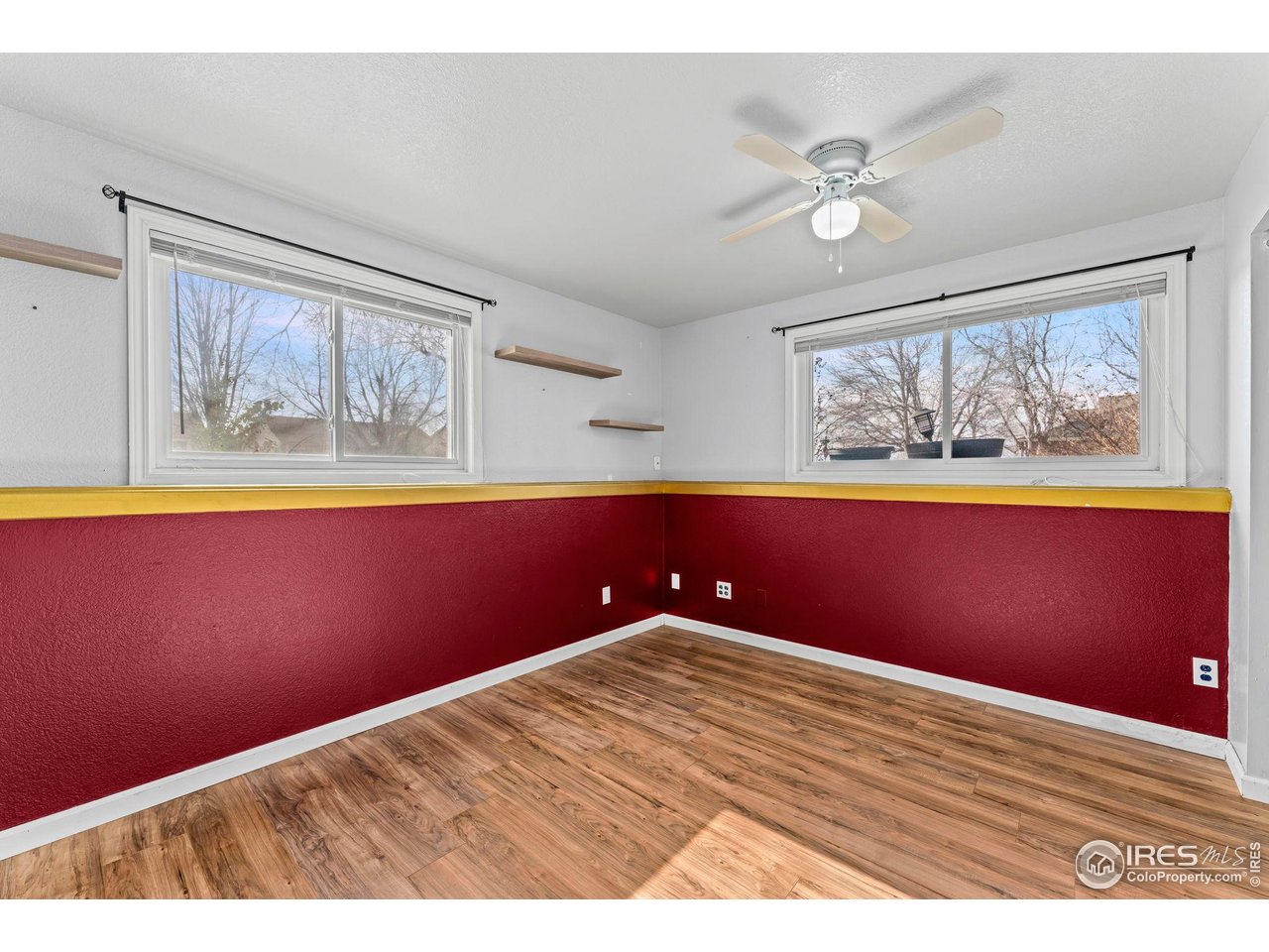 124 Adams Way Firestone, CO 80520 - Photo 20 of 34 a view of empty room with wooden floor and fan