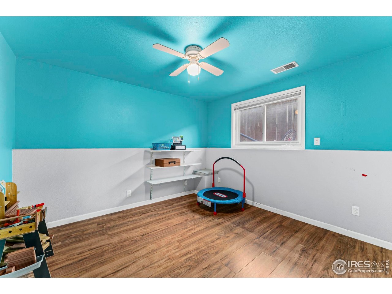 124 Adams Way Firestone, CO 80520 - Photo 21 of 34 a living room with a couch and a ceiling fan