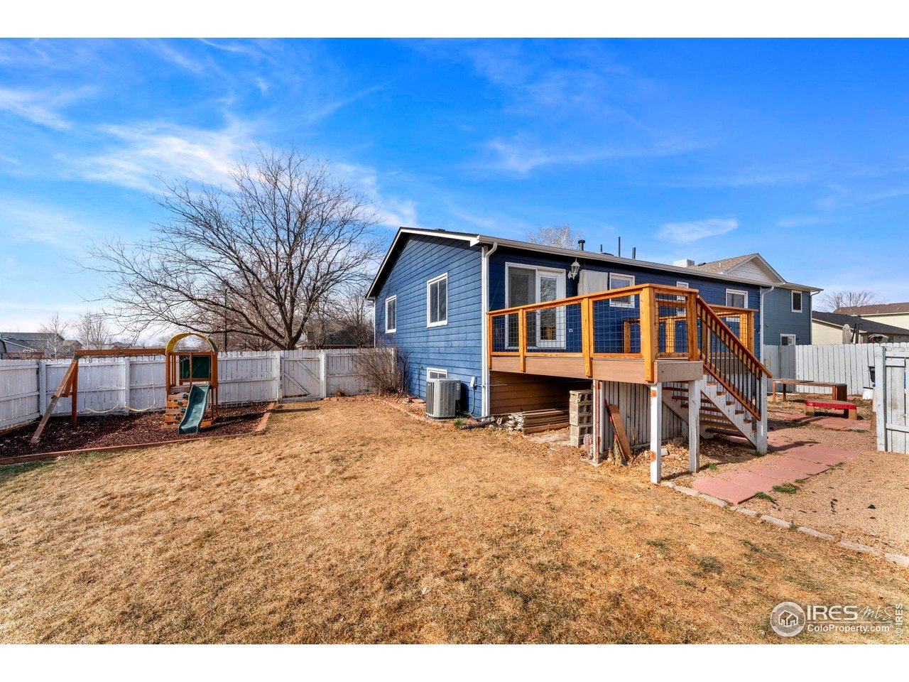 124 Adams Way Firestone, CO 80520 - Photo 24 of 34 a view of a house with a yard covered in snow